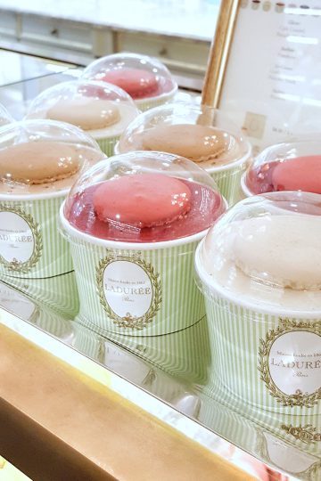 Several rows of single serve ice creams served inside a cup printed with Parisian style aesthetics.