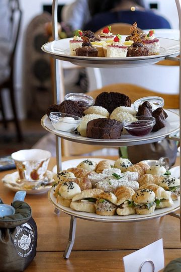 Afternoon tea display featuring assorted pastries, scones, and desserts at The Secret Garden.