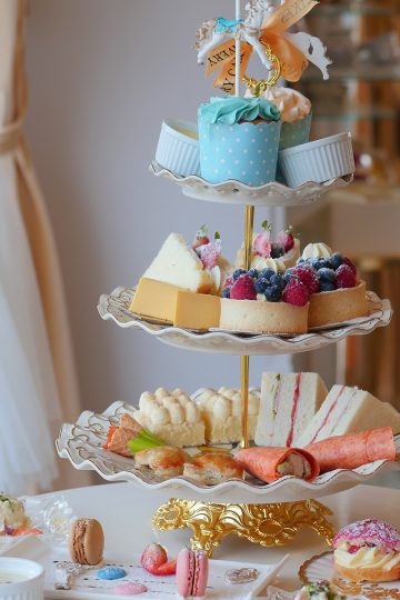 Avery afternoon tea set on a modern 3-tier set with cute style sweet treats in fun colors on it.
