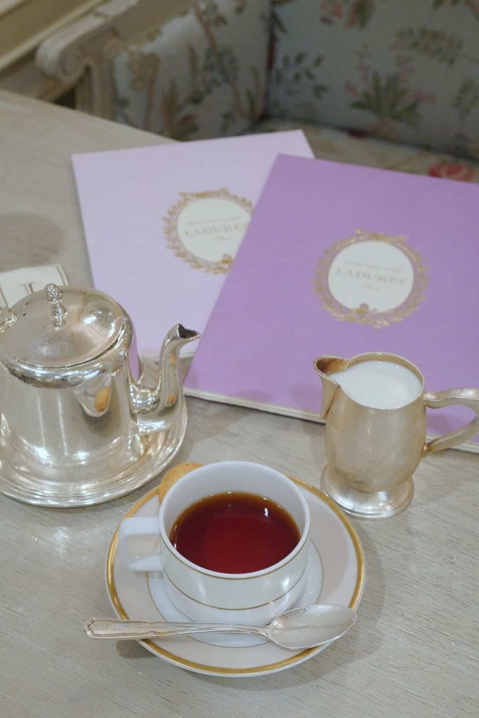 Tea cups and menus on a table.