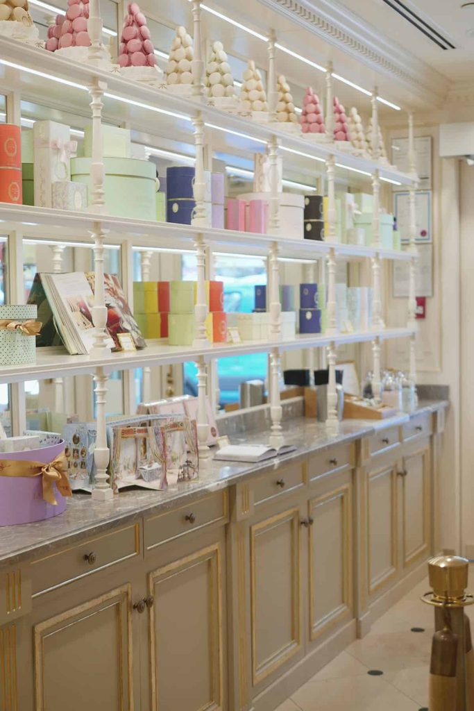 Gifts lined up on shelves at Laduree.