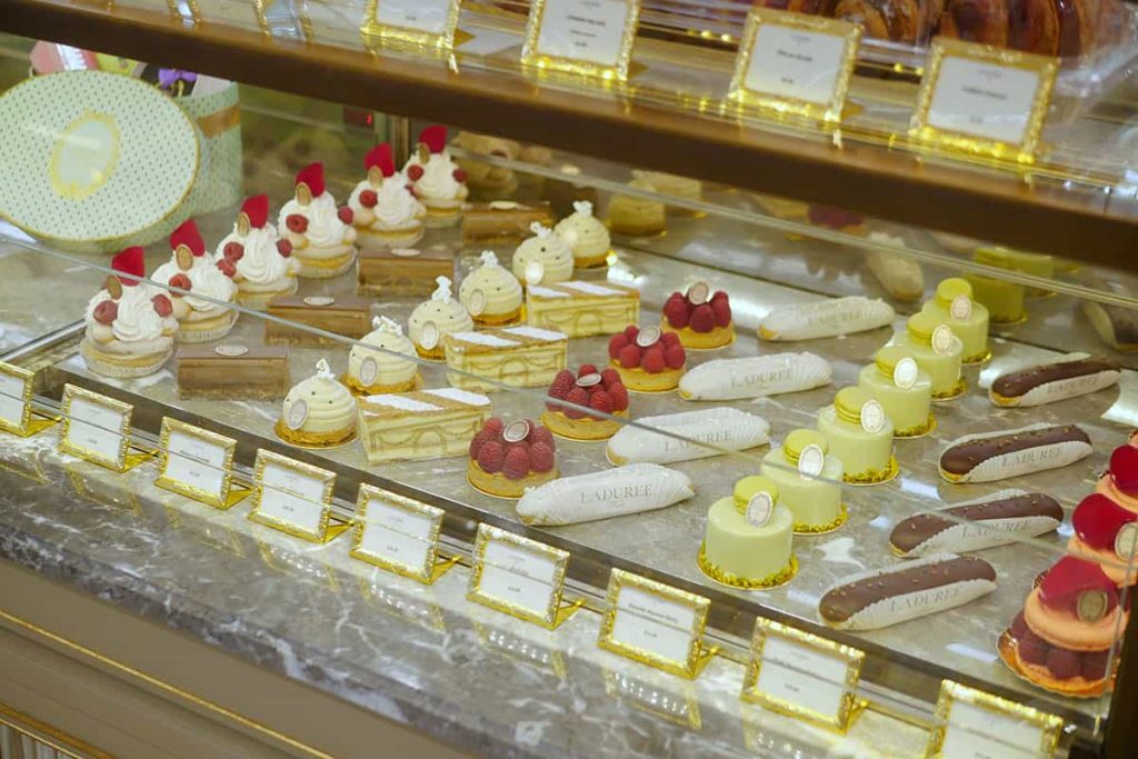 New laduree desserts lined up in display case.