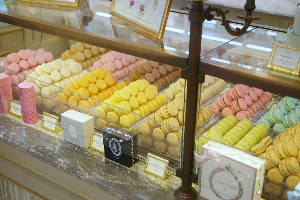 Piles of macarons inside a display case. 